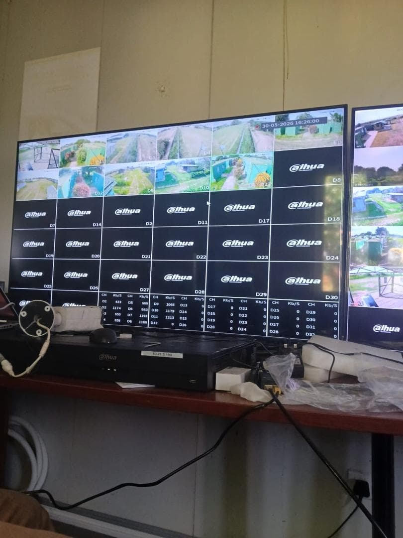 Live monitoring dashboard running across a bank of screens